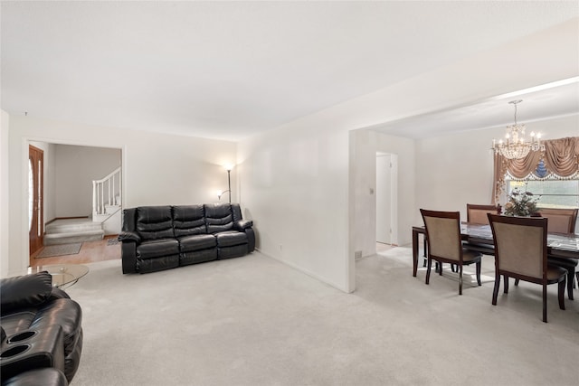 living room featuring light carpet and an inviting chandelier