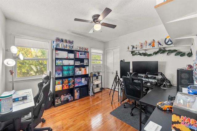 home office with hardwood / wood-style floors, a textured ceiling, a healthy amount of sunlight, and ceiling fan