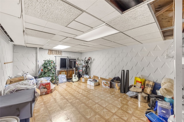 basement with a paneled ceiling