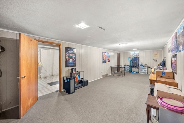 playroom featuring a textured ceiling and wooden walls