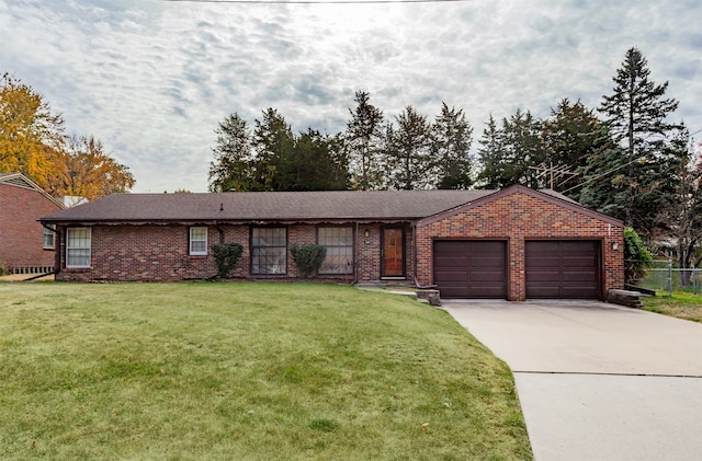 ranch-style home featuring a front lawn and a garage