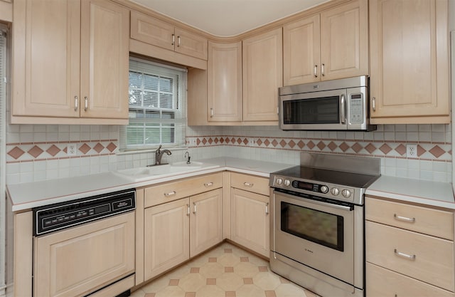 kitchen with light brown cabinets, decorative backsplash, stainless steel appliances, and sink