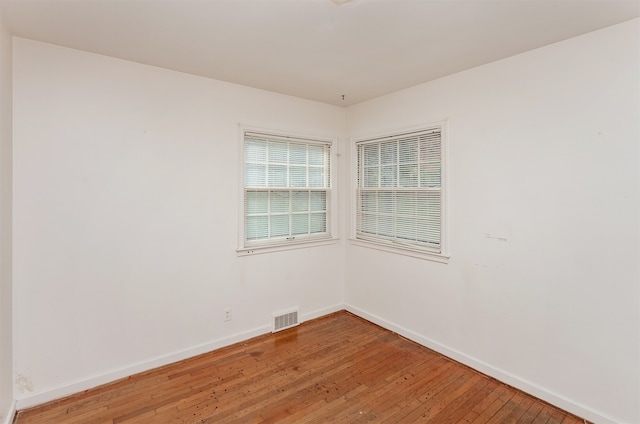 spare room with hardwood / wood-style floors