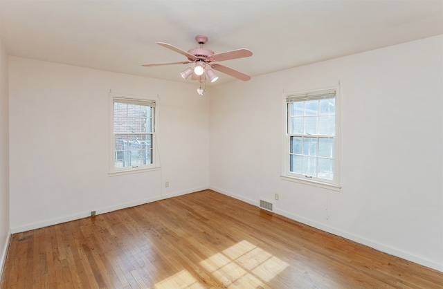 unfurnished room featuring light hardwood / wood-style flooring, ceiling fan, and plenty of natural light