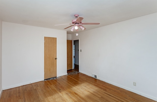 spare room with light wood-type flooring and ceiling fan