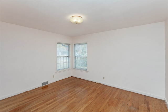 empty room with light hardwood / wood-style flooring