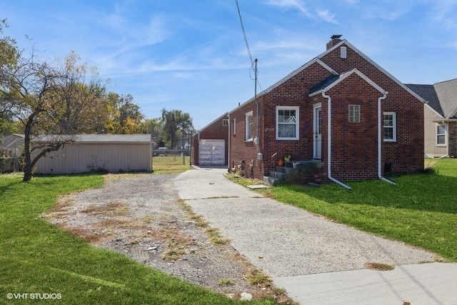 view of side of property with a garage, an outdoor structure, and a lawn