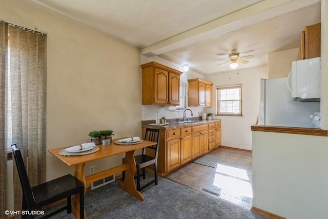 kitchen featuring ceiling fan, white appliances, light tile patterned floors, and sink