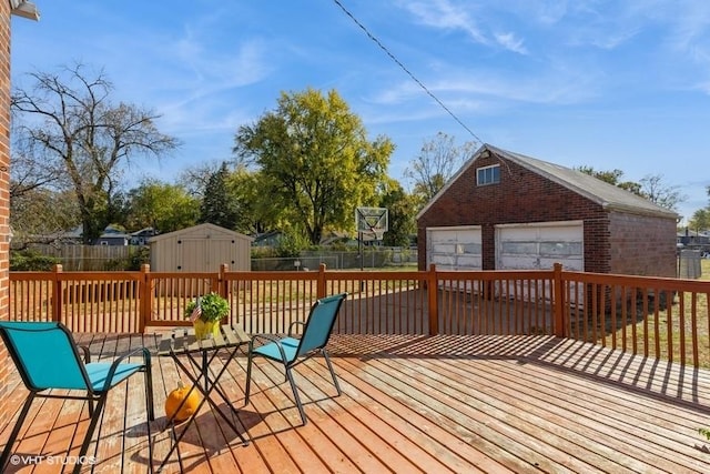 wooden deck featuring a garage and a storage shed