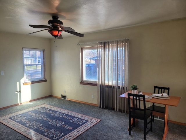 unfurnished office with ceiling fan and carpet