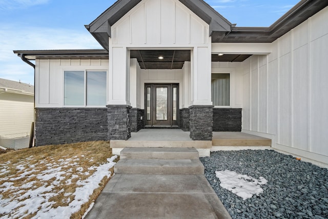 view of snow covered property entrance