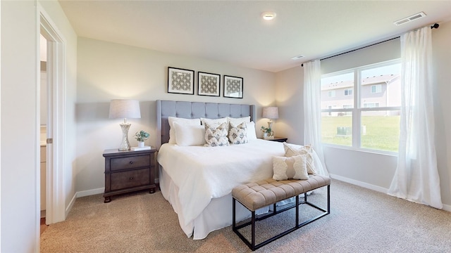 bedroom featuring light carpet