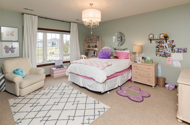 carpeted bedroom featuring a chandelier