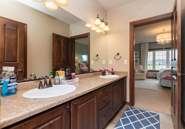 bathroom with tile patterned floors, vanity, and a chandelier