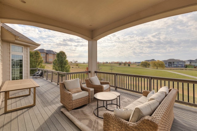 wooden terrace with an outdoor living space