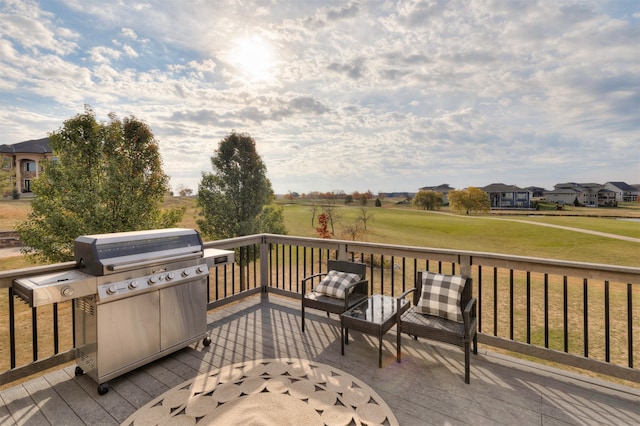 wooden deck featuring a lawn