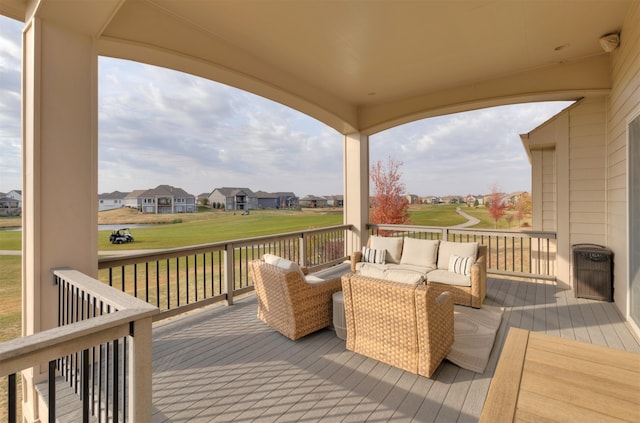 wooden terrace with an outdoor living space