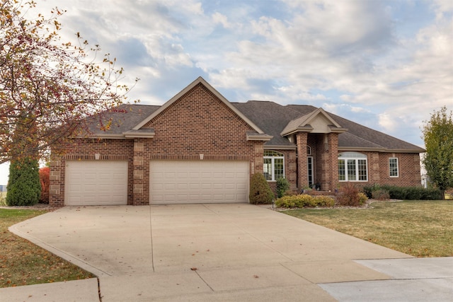 view of front of property with a garage and a front lawn