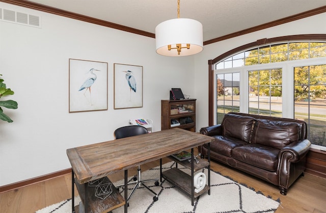 office area featuring light hardwood / wood-style flooring and crown molding