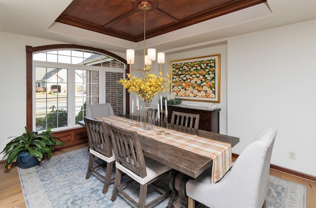 dining room featuring a tray ceiling, hardwood / wood-style floors, wood ceiling, and an inviting chandelier