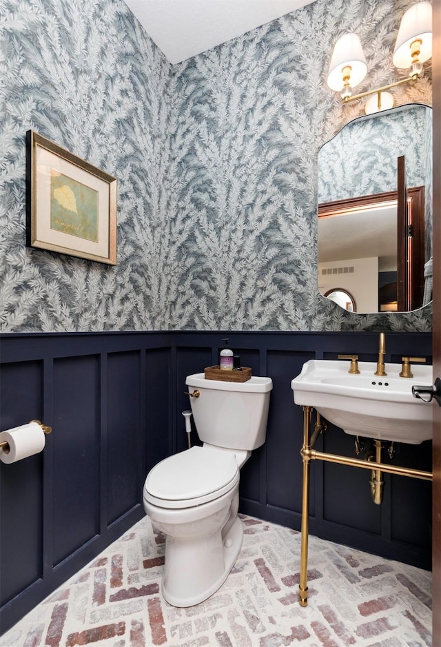 bathroom featuring sink and toilet