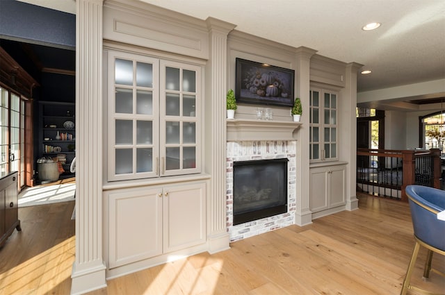 living room with a fireplace and light hardwood / wood-style flooring