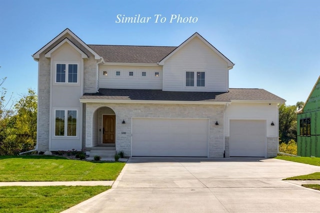 view of front facade with a front lawn and a garage