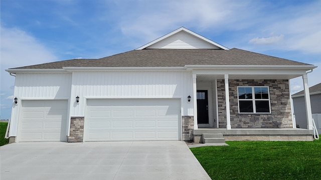 view of front of property featuring a garage and a front lawn