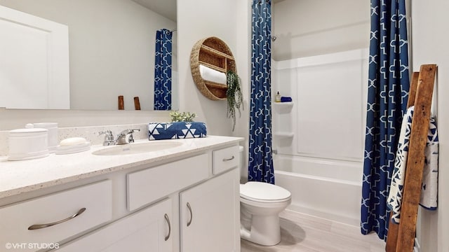 full bathroom featuring toilet, shower / tub combo, hardwood / wood-style floors, and vanity