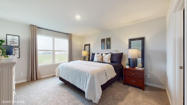 bedroom with baseboards and light carpet