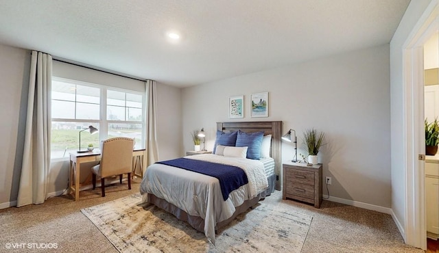 bedroom featuring baseboards and light carpet