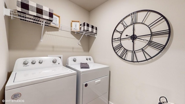 clothes washing area featuring laundry area and washing machine and dryer