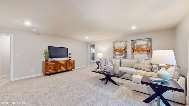 living room with baseboards, light carpet, and recessed lighting