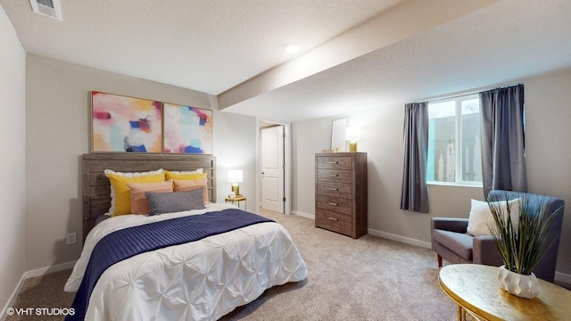 bedroom featuring visible vents, baseboards, and light colored carpet