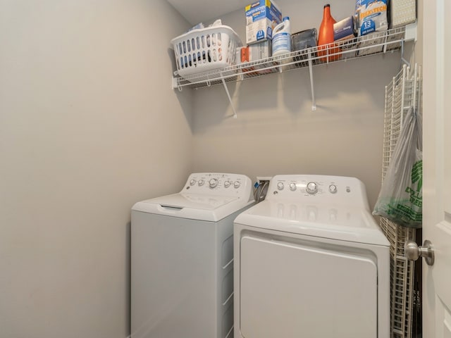 clothes washing area featuring separate washer and dryer