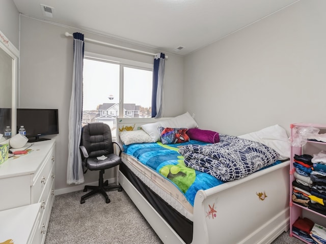 bedroom featuring light colored carpet