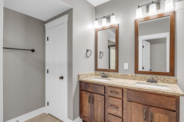 bathroom with tile patterned floors and vanity