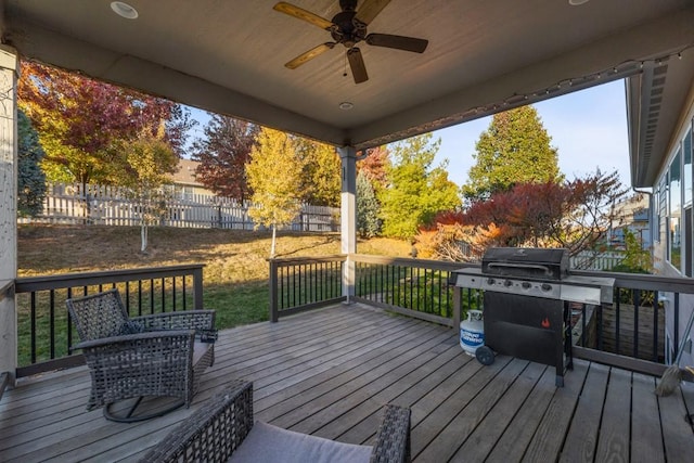 wooden deck with area for grilling and ceiling fan