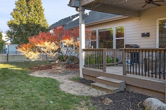 view of yard featuring a wooden deck and ceiling fan