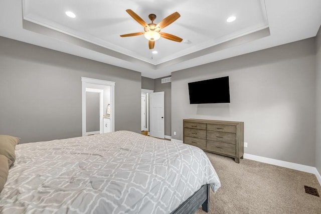 bedroom with ceiling fan, a raised ceiling, and carpet floors