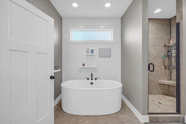 bathroom with tile patterned flooring and separate shower and tub