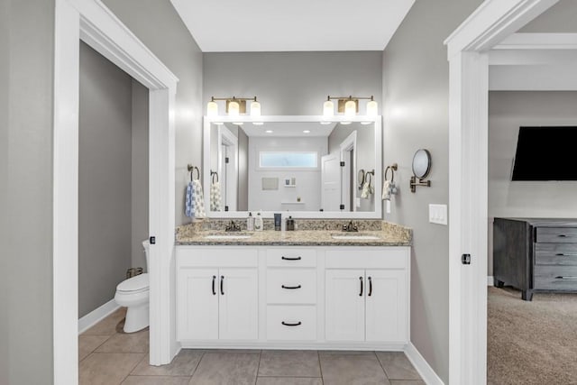 bathroom with vanity, toilet, and tile patterned flooring