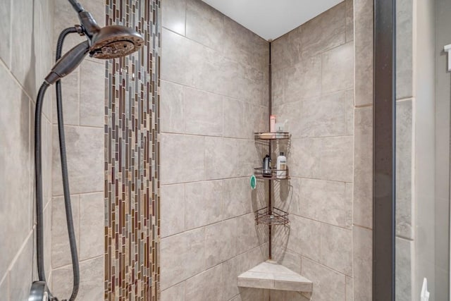 bathroom with a tile shower