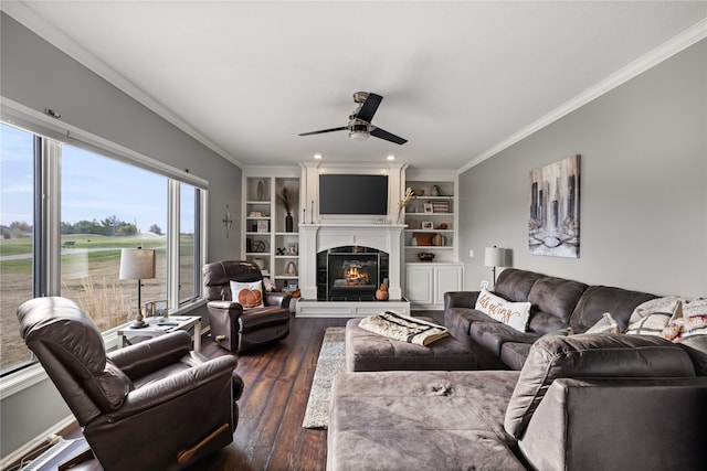 living room with ornamental molding, dark wood-type flooring, and ceiling fan