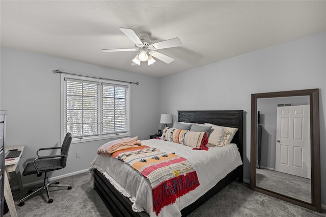 bedroom with ceiling fan, carpet, and a textured ceiling