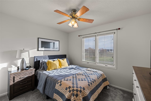 carpeted bedroom with ceiling fan and a textured ceiling