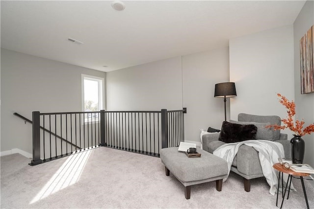 sitting room featuring light carpet