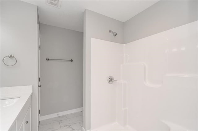 bathroom featuring vanity and a shower