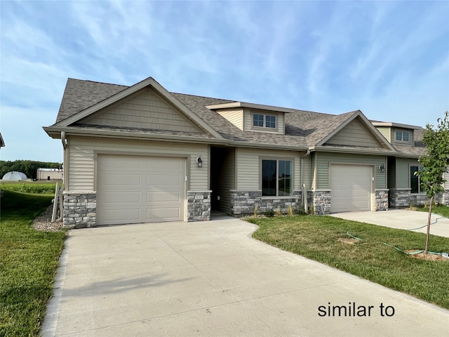 craftsman-style home with a front yard and a garage