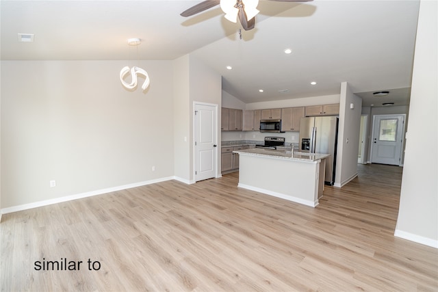 kitchen featuring light hardwood / wood-style flooring, a center island with sink, stainless steel appliances, and hanging light fixtures